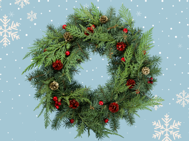 Holiday wreath on blue background with snowflakes behind