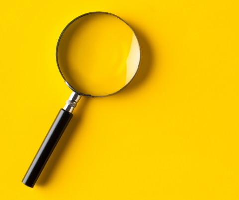 magnifying glass on yellow background