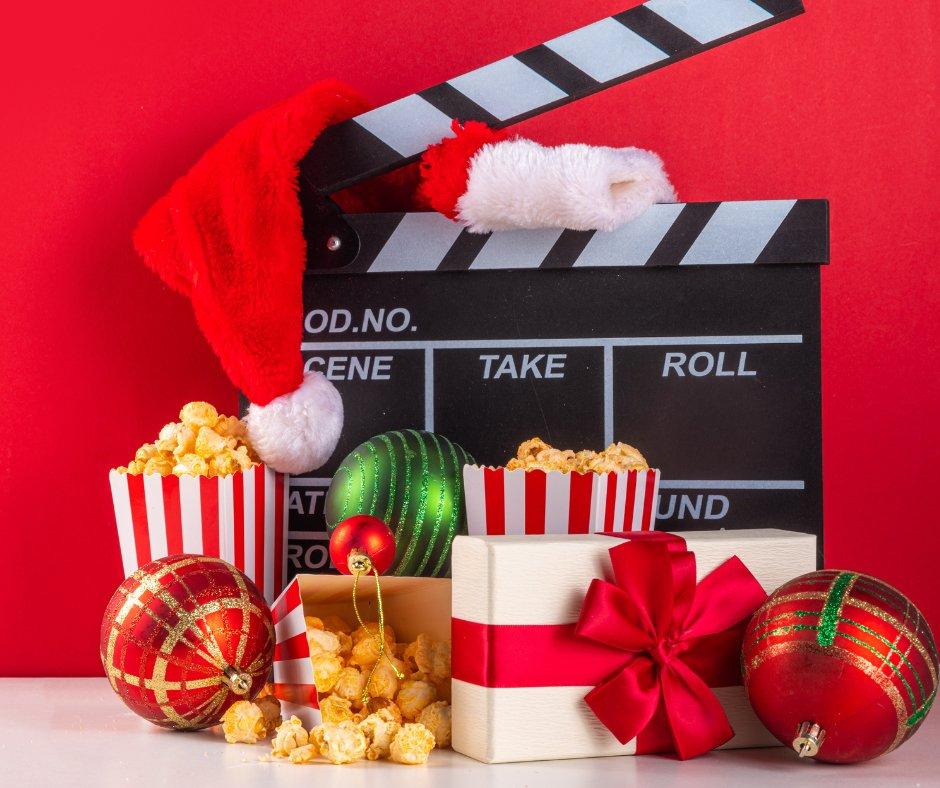 Movie clapboard surrounded by ornaments and presents