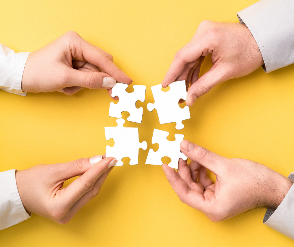 hands holding puzzle pieces