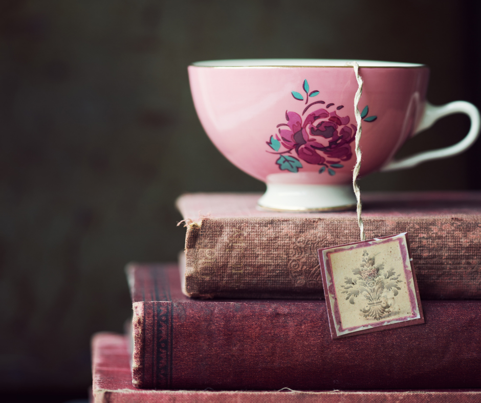 Pink floral teacup on stack of pink books